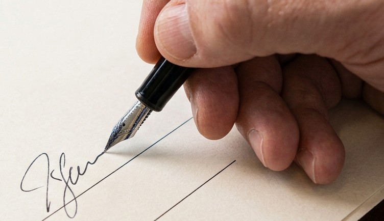 A certification being signed